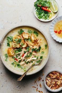 a bowl of soup with chicken and vegetables on the side