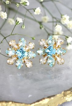 Blue Earrings, Bridal Blue Earrings, Aquamarine Stud Earrings, Bridal Cluster Earrings, Bridesmaids Earrings, Swarovski Light Blue Earrings IF YOU WANT THE BEST CHOSE THE ORIGINAL Details: Petite Delights is an Official SWAROVSKI® Branding Partner Official Swarovski Elements® Partner Made Blue Clip-on Earrings For Wedding, Elegant Blue Clip-on Earrings For Weddings, Blue Clip-on Earrings For Anniversary, Light Blue Earrings, Crystal Aquamarine, Climbing Earrings, Bridesmaids Earrings, Aquamarine Studs, Emerald Earrings