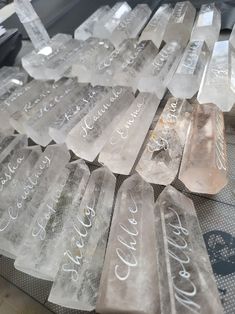 several pieces of ice sitting on top of a metal table next to each other with writing on them