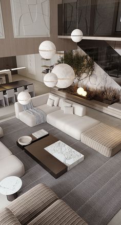 a modern living room with white couches and large lamps hanging from the ceiling above