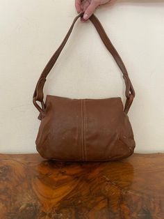 "Vintage Brown Leather purse, shoulder bag, 1970s, slightly distressed, Boho purse, Whiskey brown, Hippie purse Nice solid all leather 1970s brown leather purse Good condition, sound construction some light marks on the back. No damage Flap over closure 3 seperate sections. 1 zippered 1 center 1 large main section Measurements: 9\" x 13\" x 3\" Strap drop: 15\" NK528DR Vintage Brown Leather purse, shoulder bag, 1970s, slightly distressed, Boho purse, Whiskey brown, Hippie purse" Vintage Brown Hobo Bag, Vintage Brown Hobo Bag For Everyday, Vintage Hobo Satchel For Everyday Use, Retro Brown Satchel With Removable Pouch, Retro Brown Satchel Shoulder Bag, Vintage Leather-lined Hobo Satchel Bag, Vintage Brown Leather Hobo Bag, Vintage Soft Leather Hobo Shoulder Bag, Vintage Brown Shoulder Bag Satchel