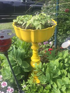 a yellow planter sitting on top of a lush green field