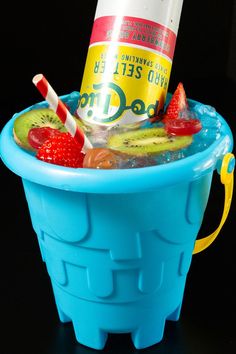 A sand bucket filled with a cocktail that's topped with fresh fruit, candy, and hard seltzer. Vodka Bucket Recipe, Sand Bucket Drinks, Beach Bucket Drinks, Bucket Drinks, Yummy Cocktails, Fun Drink Recipe, Sand Bucket, Bach Bash, Fun Summer Drinks