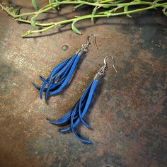 "-These tassel earrings are made from soft cadet-blue deerskin leather. Part Western, part Boho, part Rock 'n Roll, these little fringe earrings give a big kick to any outfit. -Lightweight enough to wear every day. -3\" - 3.5\" total length, including earwires. -Earwires are silver-color. -Deerskin leather is sustainably sourced in the USA. -Ok to get wet. -Available in 13 colors. -Designed and handmade in South Pasadena, CA. Check out more of our awesome earrings here: https://www.etsy.com/shop Bohemian Blue Leather Earrings, Blue Bohemian Leather Earrings, Blue Leather Bohemian Earrings, Bullet Shell Jewelry, Leather Tassel Earrings, Black Statement Earrings, Repurposed Necklace, Cadet Blue, Striped Earrings