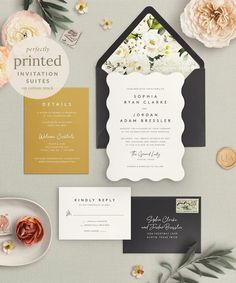 the wedding stationery is laid out with flowers and other things to include, such as an envelope