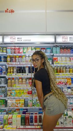 a woman standing in front of a store display