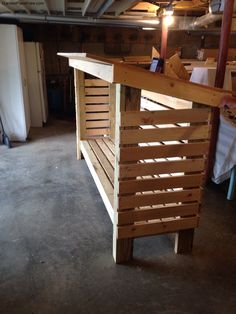 a wooden bench made out of pallets in a garage