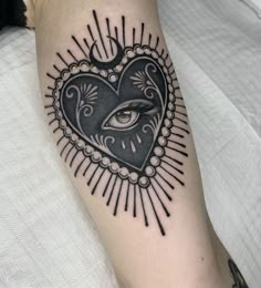 a heart tattoo with an all seeing eye