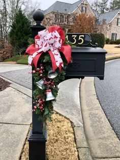 a mailbox decorated with a wreath and bells