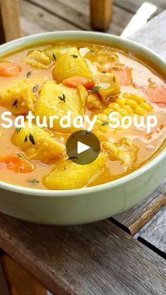 a bowl of soup sitting on top of a wooden table