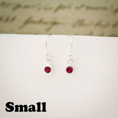 Solitary January Birthstone Earrings, Garnet Jewelry, January Birthday Gift, January Birthstone Jewelry, January Earrings, Sterling Silver Lovely Single Drop January Birthstone Garnet Crystal Colored Earrings. For babies born in January, the garnet is the perfect gem to represent their birthstone. This beautiful stone, which is most commonly red but can be found in a range of other colors, symbolizes peace, prosperity and good health. Some say it even has the power to give the wearer eternal hap Nickel Free Sterling Silver Earrings For Birthday, Nickel-free Sterling Silver Earrings For Birthday, Birthday Dangle Single Earring, Nickel-free Earrings For Birthday, Minimalist Dangle Birthstone Earrings, Classic Hypoallergenic Crystal Earrings As Gift, Dainty Gemstone Crystal Earrings For Gift, Dainty Crystal Gemstone Earrings For Gift, Red Dainty Earrings For Anniversary