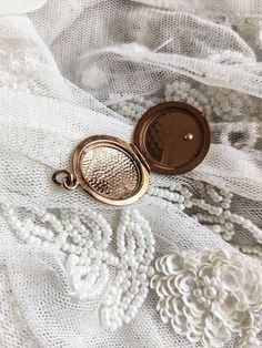 Beautiful antique gold plated locket with a small stone in dark blue glass paste. Good overall antique condition, some wear and tear consistant with the age of the jewel. The plating is gone in places, especially on the sides. Size: about 2.3 cm in diameter. Possible colour variations due to the light. Victorian Brass Jewelry With Coin Pendant, Victorian Brass Coin Pendant Jewelry, Antique Yellow Gold Locket Necklace With Charms, Antique Charms Locket Necklace For Keepsake, Antique Gold Victorian Round Locket Necklace, Antique Coin Pendant Jewelry, Victorian Jewelry With Coin Pendant, Antique Charms Locket Necklace For Wedding, Heirloom Brass Locket Necklace Hallmarked