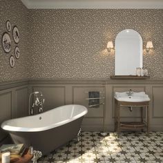 a bathtub and sink in a bathroom with wallpapered walls, flooring and decor