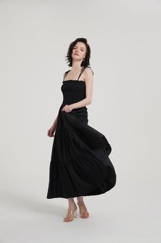 This timeless Tiered Ruffle Slip Maxi Dress will become a wardrobe staple. Crafted from a lightweight blend of 55% Cotton and 45% Modal, it features a spaghetti shoulder strap, straight neck, smocking bodice, eye-catching 3D piping detail along the tiered seam, two side pockets, and an unlined finish. Perfect for summer evenings. Spaghetti shoulder strap Straight neck Smocking bodice 3D piping detail along the tiered seam Two side pockets Unlined (in) S M L Length (Excluding Suspenders) 44.1 44. Black Tiered Maxi Dress With Ruffle Hem, Black Tiered Maxi Sundress, Black A-line Maxi Dress With Ruffles, Chic Tiered V-neck Dress With Ruffle Hem, Slip Maxi Dress, Urban Outfitters Black V-neck Dress, Semi Annual Sale, Active Wear Pants, Summer Evening