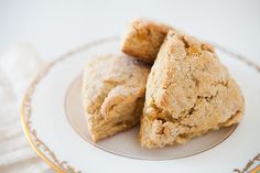 three pieces of biscuit sitting on top of a plate next to each other,