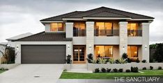 a two story house with large windows and landscaping