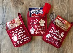 three red bags filled with treats sitting on top of a wooden floor next to each other