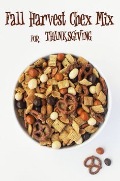 a bowl filled with nuts and pretzels on top of a white table next to the words fall harvest chex mix for thanksgiving