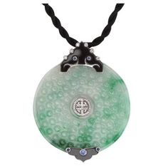 Simply Beautiful! Featuring a Stunning Vintage Hand Carved Jade Disc, enhanced by Diamonds, Sapphires. Hand crafted 18K White Gold Pendant suspended from a Silk cord. Green Jade (A-grade), untreated, "Py Stone" disc diameter measures approx. 55 mm. 2 untreated Black Nephrite Fancy elements; 50 round Brilliant cut Diamonds, weighing approx. 0.30tcw, H / SI and 5 round Sapphires, approx. 0.22tcw. More Beautiful in real time! Classic and Timeless and Sure to be admired...A piece you'll turn to time Diamond Gold Pendant, Art Deco Pendant Necklace, Jewel Design, Round Sapphire, White Gold Pendant, Vintage Necklaces, Circle Diamond, Rose Gold Pendant, Sapphire Pendant