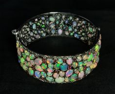 Natural Ethiopian Opal - 925 Silver Bangle. Description:- 925 Sterling Silver, Opal Stone Bangle, Gifted Bangle, Gift For Girl, Woman Fine Jewelry. Gross weight - 49.320 Gram Silver weight - 38.620 Gram Opal weight - 49.30 Carat Rhodolite stone weight - 4.20 Carat Shape of stone - as shown these images Cut Grade - Smooth Quality - AAA Origin - Ethiopia Opal Hardness - 5.5 - 6.5 Color - Multi Color Bangle size - See variation select your Wrist Size                                        ( Home Pa Opal Bangle, Gemstone Bangle, Stone Bangle, Silver Bangle, Silver Bangles, Opal Gemstone, Ethiopian Opal, Gifts For Girls, Home Page