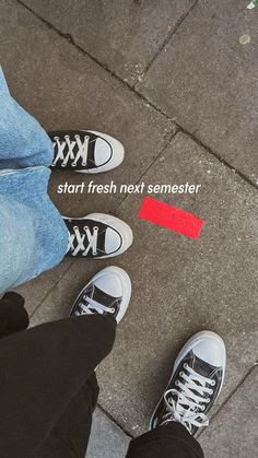 two people standing next to each other with their feet on the ground near a red line