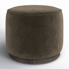 a brown ottoman sitting on top of a white floor