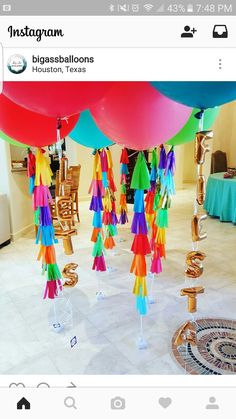 colorful streamers and balloons are hanging from the ceiling