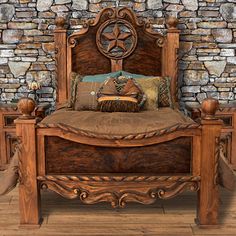 a wooden bed sitting in front of a stone wall