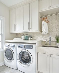 a washer and dryer in a white laundry room