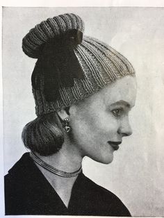 an old black and white photo of a woman wearing a hat with a bow on it