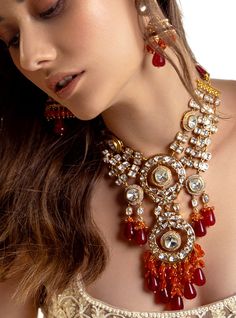 Multi Coloured Polki Bridal Necklace Set - Joules By Radhika Radiate romance with our 22Kt Gold Plated necklace set, a perfect match for brides on their wedding day. The enchanting Hydro Polkis, complemented by alluring red Agate drops and vibrant carnelian beads, create a captivating ensemble. Embrace the elegance and charm of this exquisite set, adding a touch of sophistication to your bridal allure. SET INCLUDES: Necklace and Earrings Details: Handcrafted with ❤️ Metal: Brass Product Type: Ne Yellow Gold Kundan Necklace With Stone Work For Wedding, Fusion Chandbali Jewelry Sets For Wedding, 22k Gold Bridal Earrings For Wedding, 22k Gold Wedding Necklace, Yellow Gold Kundan Necklace With 17 Jewels For Wedding, 22k Gold Kundan Necklace Hand Set For Wedding, Bollywood Style 22k Gold Kundan Necklace For Wedding, Elegant Wedding Necklace With Fusion Style, Elegant Fusion Wedding Necklaces