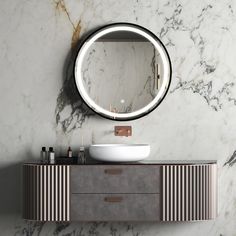 a bathroom vanity with a round mirror on the wall above it and a sink below