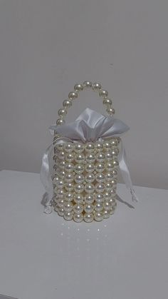 "Elevate your style with our exquisite Pearl Bag collection. Explore the allure of pearls with our curated range, including the graceful \"Pearl Purse for Bride,\" the charming \"Pearl Handle Gift Bag,\" and the elegant \"Pearl Clutch for Wedding.\" Handcrafted with meticulous attention, each bag showcases the timeless beauty of pearls, adding a touch of sophistication to your ensemble. For those seeking a blend of tradition and modernity, our \"Pearl Beaded Bag\" captures the essence of refined elegance. Details: Completely handmade Pouch gift inside. Made of quality pearl beads. Pearl beads that do not fade and do not change colour. Size:  Width: 10 cm (3,9 inches) Length: 20 cm (7.8 inches) It can be made according to your request with silver, gold and white details. 💖 Optionally, a st Purse For Bride, Pearl Beaded Bag, Pearl Purse, Pearl Clutch Bag, Pearl Handbag, Bridal Clutch Bag, Hand Beaded Bag, Beaded Clutch Purse, Beaded Clutch Bag