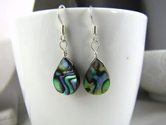 "Abalone Earrings - choice of silver plated or sterling silver at checkout This is a listing for 1 pr of earrings. I included pics of both so you can see that every pr will have its own unique pattern. Choice of silver plated or sterling silver at checkout The silver plated wires are hypoallergenic nickel and copper free. They dangle down almost 1 1/2\" from the top of the ear wire or 36 mm for my metric friends. Please see pic in hand for size reference. These come in a cute gift bag. I can mak Adjustable Teardrop Pendant Earrings As Gift, Unique Teardrop Sterling Silver Earrings, Pierced Teardrop Pendant Earrings As Gift, Pierced Teardrop Pendant Earrings For Gift, Handmade Sterling Silver Teardrop Pendant Earrings, Unique Silver Dangle Teardrop Earrings, Silver Teardrop Pendant Earrings As Gift, Unique Silver Teardrop Dangle Earrings, Sterling Silver Long Drop Teardrop Earrings For Gift