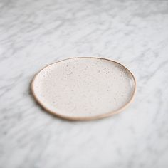 a white plate sitting on top of a marble counter