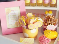 a table topped with lots of yellow and pink items