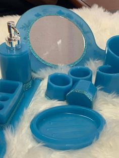 a blue bathroom set with soap dispenser, toothbrush holder and other items