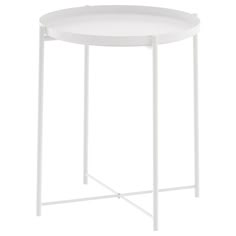 a white side table with metal legs and a round tray on the top that is holding a