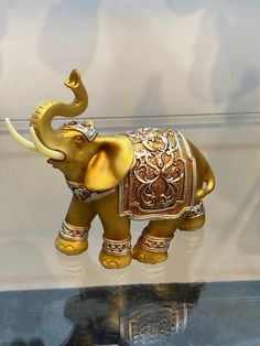 an elephant figurine on display in a glass case