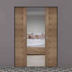 an open door to a bedroom with a bed in the background and patterned flooring