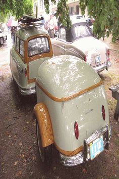 an old car is parked next to other cars