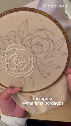 someone is holding up an embroidery project with flowers on it and the words instagramma bordados