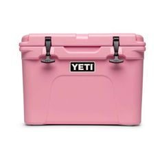 the yeti cooler is pink and has two handles on each side, with black latches