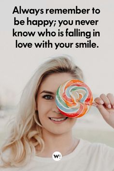 a woman holding a lollipop in front of her face with the caption always remember to be happy you never know who is falling in love with your smile