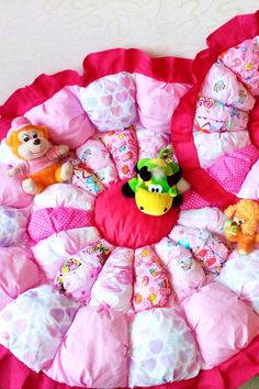 there are many stuffed animals on the pink beddings and pillows in this room