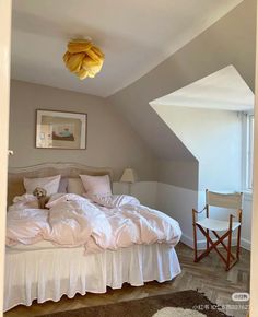 a bed with white sheets and pillows in a room