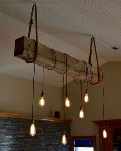 a bunch of lights that are hanging from the ceiling in a room with stone walls