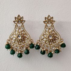 These exquisite Bottle Green Crystal and Pearl Embellished Kundan Earrings, perfect for adding a touch of elegance to your Indian or Pakistani attire. The rich bottle green hue, combined with intricate kundan craftsmanship and delicate pearl accents, makes these earrings a stunning accessory for any special occasion. Embrace the beauty of cultural craftsmanship and make a statement with these beautifully designed earrings that effortlessly blend tradition and style. Materials: Brass, Pearl, Kundan, Crystal ❋❋ Shipping Methods ❋❋ Standard Delivery - Take up to 8-14 business days (Worldwide). ❋❋ Please be aware that the colors, shades, and texture shown may exhibit minor variations compared to the actual product due to limitations in digital imaging. We kindly ask for your understanding and Elegant Green Chandbali Danglers, Elegant Green Danglers For Celebration, Elegant Green Drop Earrings, Elegant Green Chandelier Earrings For Festive Occasions, Elegant Green Bridal Earrings For Festive Occasions, Elegant Green Danglers As Gift, Elegant Green Danglers As A Gift, Elegant Green Danglers For Gift, Elegant Green Danglers For Festive Occasions