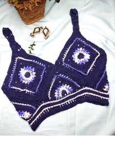 This blue sunflower crop top is best for festivals, birthday parties, and beachwear. This is a sleeveless crop top with a deep V-neck. The back of the dress contains a nice criss-cross pattern. This is a quality piece of crochet wear and 100% handmade in Sri Lanka. The top is crocheted with soft cotton wool yarns and gives a smooth feeling when you are wearing it. **Please double-check your measurements with the size chart displayed in the images section above, before you purchase the product as we do not refund or exchange. **There can be a slight color difference between the product and the displayed images due to lighting differences. Fitted Tank Top For Beach Vacation, Fitted Tops For Summer Beach Party, Multicolor Sleeveless Tops For Beach Party, Summer Cotton Tops For Music Festival, Sleeveless Fitted Crochet Top For Beach Party, Fitted Sleeveless Crochet Top For Beach Party, Sleeveless Summer Tops For Beach Party, Fitted Tank Top For Spring Beach Party, Sleeveless Tops For Summer Beach Party