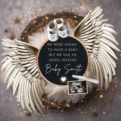 a baby announcement with angel wings and shoes